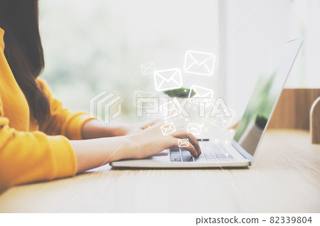 Woman hand using computer laptop pc with email icon. Concept of email and contact us 82339804