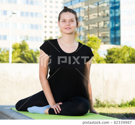 Young female during outdoor training yoga 82339987