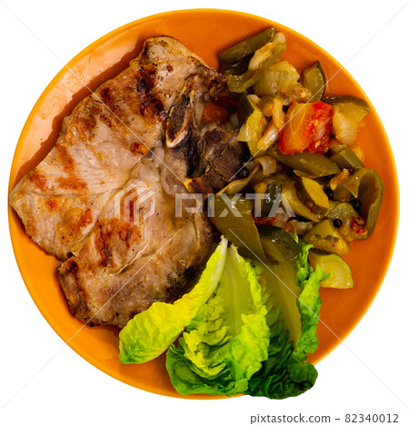 Juicy roast pork on a plate with stewed vegetables Juicy roast pork on a plate with stewed vegetables 82340012
