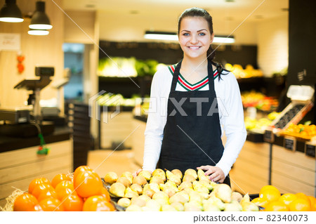 Girl deciding on fruits 82340073