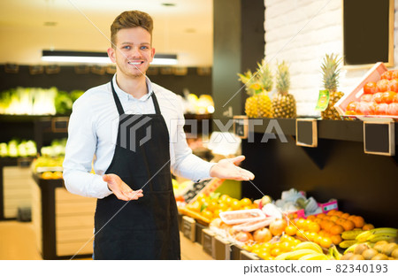 Seller showing assortment of grocery store 82340193