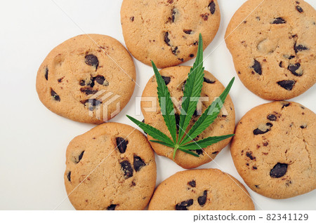 Sweets with CBD oil. Marijuana leaf on white background. Sweets with CBD oil. Marijuana leaf on white background. 82341129