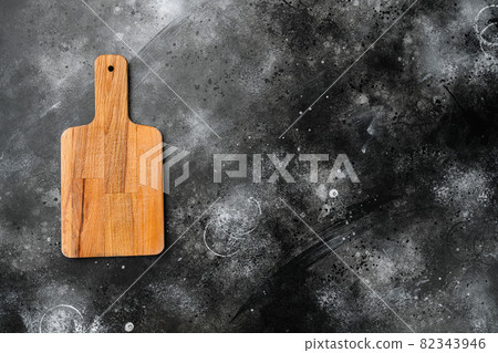 Cutting board, on black dark stone table background, top view flat lay , with copy space for text or your product Cutting board, on black dark stone table background, top view flat lay , with copy space for text or your product 82343946