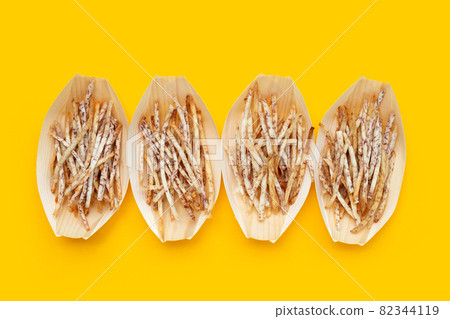 Fried taro sticks on yellow background. Fried taro sticks on yellow background. 82344119