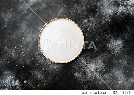 Ceramic empty white plate with copy space for text or food with copy space for text or food, top view flat lay , on black dark stone table background 82344156