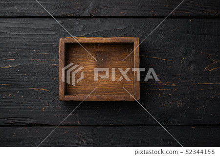 Rustic wooden box or container with copy space for text or food, top view flat lay , on black wooden table background Rustic wooden box or container with copy space for text or food, top view flat lay , on black wooden table background 82344158