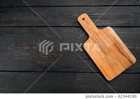 Empty vintage cutting board, on black wooden table background, top view flat lay , with copy space for text or your product Empty vintage cutting board, on black wooden table background, top view flat lay , with copy space for text or your product 82344190