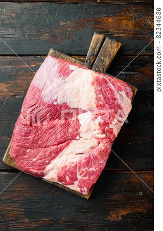 Raw veal calf brisket beef, on old dark wooden table background, top view flat lay 82344680