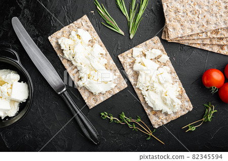 Crispbread sandwich, on black dark stone table background, top view flat lay 82345594