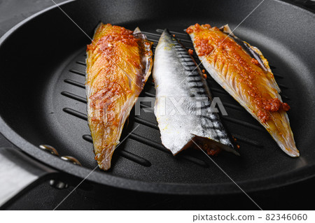 Marinated mackerel on iron cast on black background 82346060