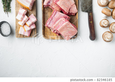 Raw beef ribs kalbi, with ingredients , and old butcher cleaver knife, on white stone background, top view flat lay, with copy space for text Raw beef ribs kalbi, with ingredients , and old butcher cleaver knife, on white stone background, top view flat lay, with copy space for text 82346185