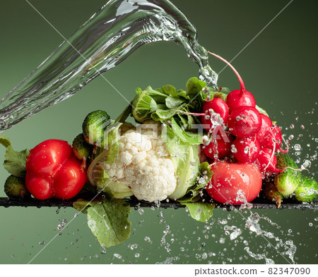 Various fresh raw vegetables with water splash. 82347090