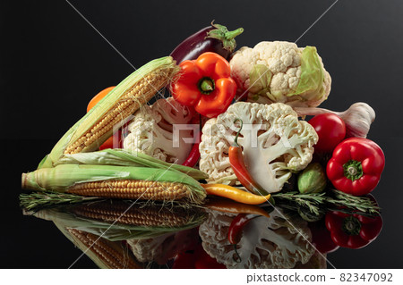 Various fresh vegetables on a black reflective background. 82347092