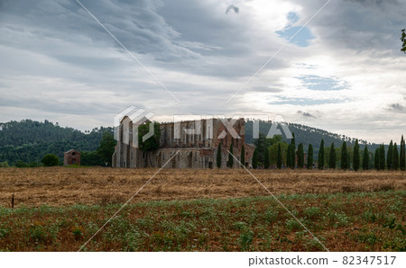 San Galgano, Chiusdino, Italy. August 2020. Stunning Tuscan landscape with the dilapidated and roofless abbey of San Galgano. 82347517