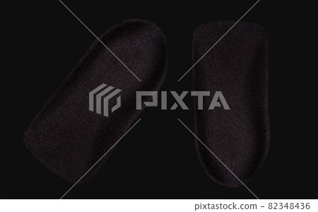 The orthopedic insole on a black background. The orthopedic insole on a black background. 82348436