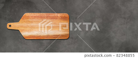 Wooden cutting board isolated on dark concrete background. Horizontal banner Wooden cutting board isolated on dark concrete background. Horizontal banner 82348855