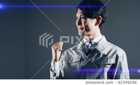 A businessman in work clothes doing a guts pose 82349298