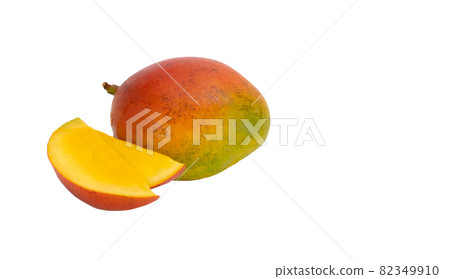 Mangifera indica. ripe mango fruit, cut into slices on a white background. 82349910