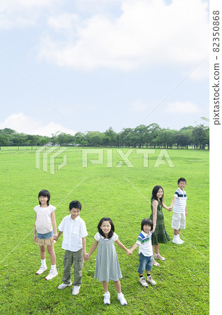 Children standing hand in hand Children standing hand in hand 82350868