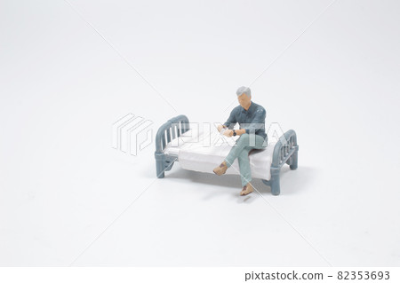 a man sit on the bed and drinking coffee 82353693