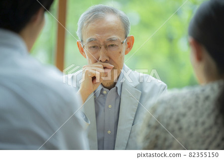 Senior man and young couple talking 82355150