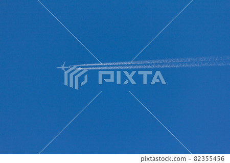 Flying plane leaves an inversion trail in the air. White and blue . nice logo 82355456