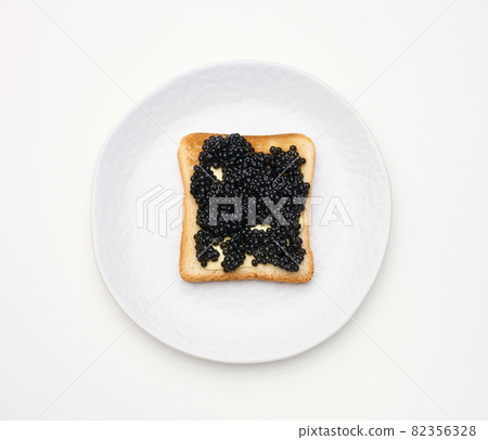 paddlefish caviar on a square slice of white wheat flour. Top view on white table paddlefish caviar on a square slice of white wheat flour. Top view on white table 82356328