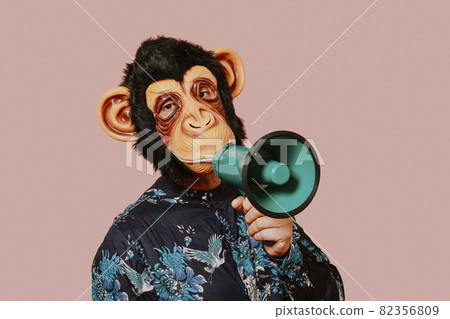 man wearing a monkey mask speaks into a megaphone man wearing a monkey mask speaks into a megaphone 82356809