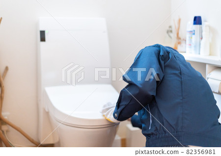 Technician doing toilet maintenance Technician doing toilet maintenance 82356981