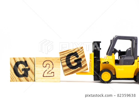 Toy forklift hold letter block G to complete word G2G (abbreviation of Government to government) on wood background Toy forklift hold letter block G to complete word G2G (abbreviation of Government to government) on wood background 82359638
