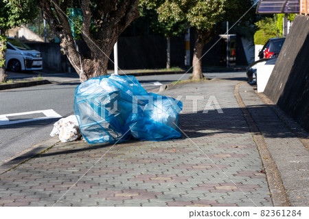 Household garbage placed in the garbage storage area in a residential area 82361284