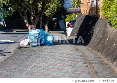 Household garbage placed in the garbage storage area in a residential area 82361286