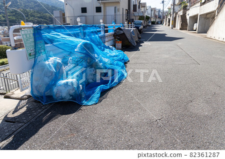 Household garbage placed in the garbage storage area in a residential area 82361287