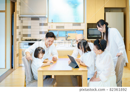 3rd generation family playing on tablet PC 3rd generation family playing on tablet PC 82361892