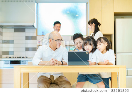 3rd generation family playing on tablet PC 3rd generation family playing on tablet PC 82361893