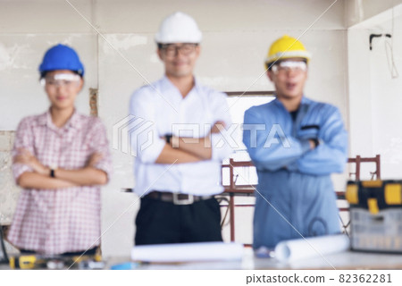 Construction engineer teamwork Safety Suit Trust Team Holding White Yellow Safety hard hat Security Equipment on Construction Site. Hardhat Protect Head for Civil Construction Engineer Concept Construction engineer teamwork Safety Suit Trust Team Holding White Yellow Safety hard hat Security Equipment on Construction Site. Hardhat Protect Head for Civil Construction Engineer Concept 82362281