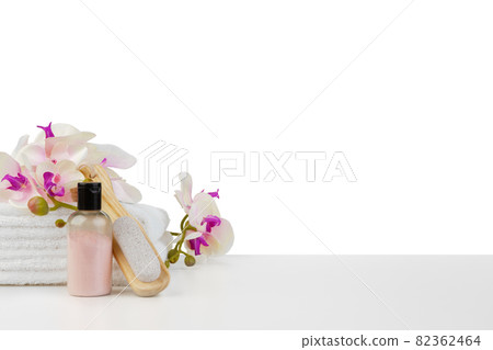 Spa composition with towels and flowers isolated on white Spa composition with towels and flowers isolated on white 82362464