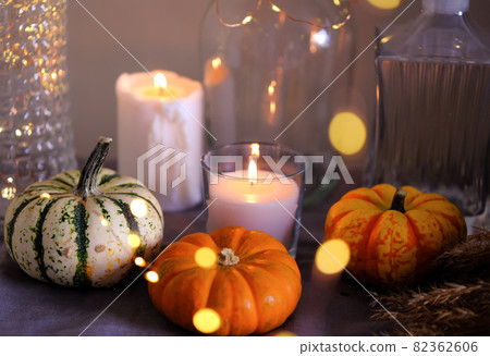 Cozy autumn home decor with candles and pumpking. 82362606