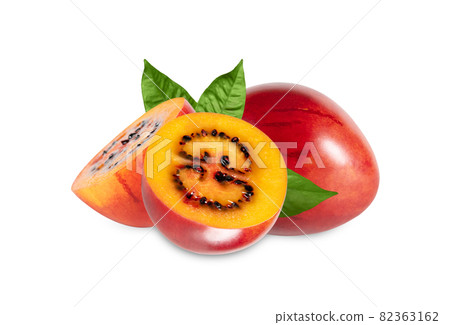 Sliced tamarillo isolated on a white background. Tamarillo with leaves close up. Juicy healthy fruit. Sliced tamarillo isolated on a white background. Tamarillo with leaves close up. Juicy healthy fruit. 82363162