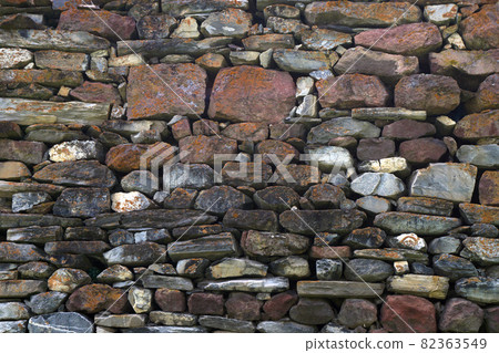 texture, background wall Laid natural stones of various sizes and colors 82363549