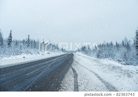Snow pass. Winter Arctic road through the hills. Snow pass. Winter Arctic road through the hills. 82363743