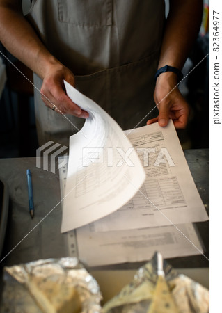 The baker looks through the recipe. Problem solving concept 82364977