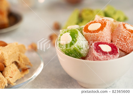 Close up of colorful Turkish halva sweets on gray surface Close up of colorful Turkish halva sweets on gray surface 82365600