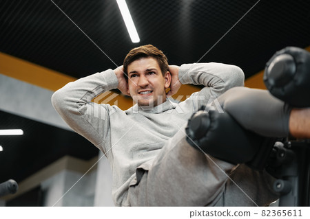 Young athlete doing abs exercises workout in modern gym 82365611