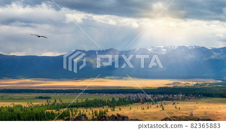 Altai village of Kurai. Wide panoramic view of the Kurai steppe in the Altai. Steppe on the background of mountains. Altai village of Kurai. Wide panoramic view of the Kurai steppe in the Altai. Steppe on the background of mountains. 82365883