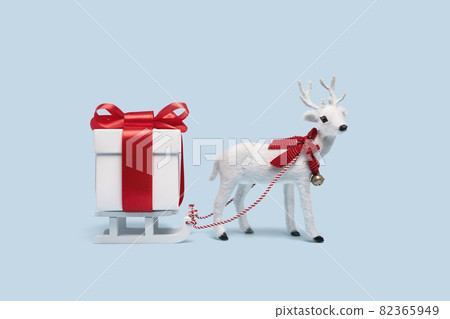 White toy reindeer on Christmas blue background White toy reindeer on Christmas blue background 82365949