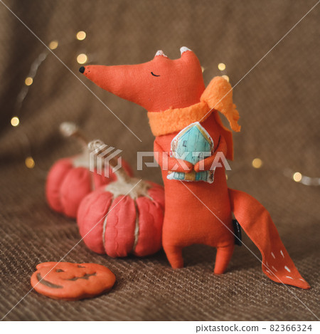 cozy autumn composition with a funny handmade toy fox, fall home decoration 82366324
