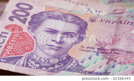 Portrait of Lesya Ukrainka in 200 hryvnia banknotes. Ukrainian paper bank notes, close-up. 82366345