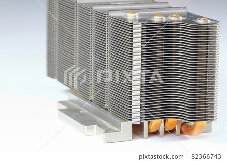 A close up view of passive CPU cooler with the aluminum fin and copper heat pipe structure isolate on white background. A close up view of passive CPU cooler with the aluminum fin and copper heat pipe structure isolate on white background. 82366743