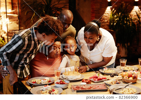 Grandmother Blowing Candles 82366900